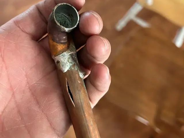 Burst copper pipe with a split along its side