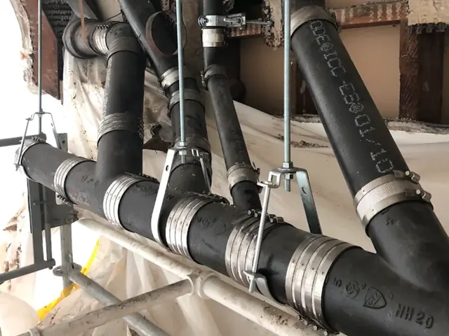New cast iron drain stack hung with steel hangers